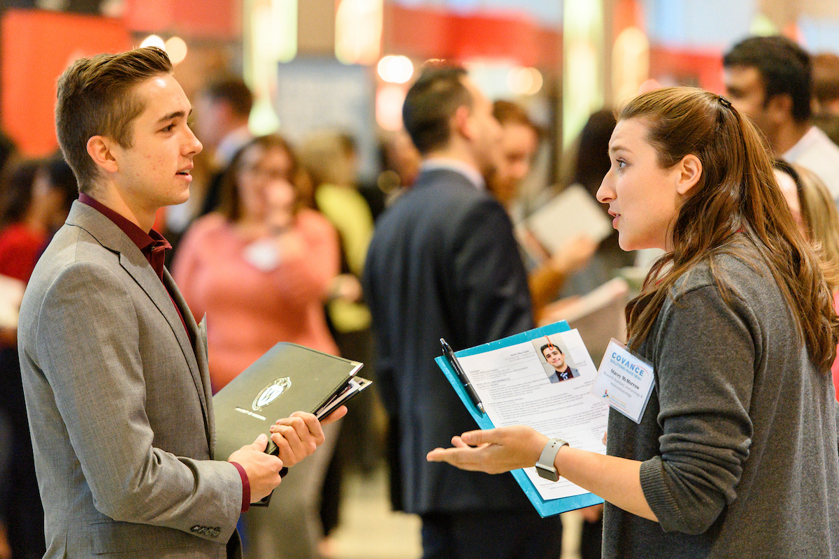 A student and an employer talking at a career fair